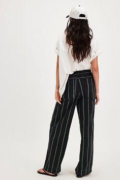 A textured take on our top-rated Hudson Canyon Pants, this slouchy pair is featured in a high-rise fit and wide-leg style with striped detailing and drawstring waistband. **Fit:** High-rise; wide, full-length legs **Features:** Textured fabrication with striped detail all over, adjustable drawstring waistband, pockets for hands, back-pocket detail **Why We ❤ It:** These billowy pants pair perfectly with your favorite tank and strappy sandals. | Hudson Canyon Textured Stripe Pants by Free People Striped Wide Leg Pants With Elastic Waistband For Work, Casual Striped Wide Leg Work Pants, Casual Striped Wide Leg Pants For Work, Chic Striped Wide Leg Pants With Relaxed Fit, Chic Striped Wide Leg Pants, Stripe Pants, Trouser Style, Striped Pants, Small Waist