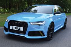 a blue car is parked on the street