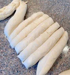 several uncooked doughs sitting on top of a counter next to a peeled banana