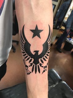 a person with a tattoo on their arm and the star is in the middle of it