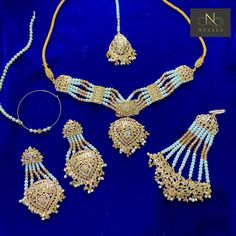 Traditional Gold-Plated Hyderabadi Bridal Complete Set  Beautiful traditional hyderabadi bridal set with intricate detailing, finished with white and champagne premium pearls. Quality of this set is a guarantee!  * Guluband * Rani Haar  * Tikka * Jhumar  * Earrings * Nath Jewellery comes in a complementary large size luxury red velvet box- perfect to keep it safe!  Please check our Instagram page @nuzeedofficial for more bridal jewellery and outfits at affordable prices. Bollywood Bridal Sets With Zari Work In White, Traditional White Bridal Sets With Zari Work, Bollywood Style White Bridal Sets With Zari Work, Traditional White Bridal Sets For Festive Season, White Meenakari Bridal Sets For Diwali, Traditional Bridal Sets With Stone Work For Reception, Traditional White Bridal Sets With Cutdana, Traditional White Bridal Sets, Traditional Kundan Bridal Sets In White