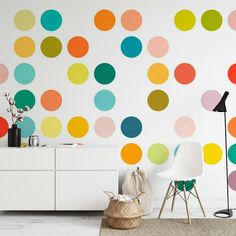 a room with colorful polka dots on the wall