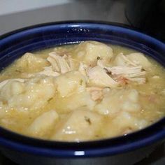 a blue bowl filled with food on top of a stove