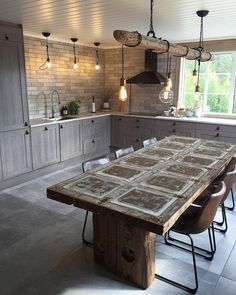 a large wooden table sitting in the middle of a kitchen