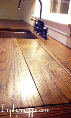 a wooden counter top with a sink and faucet