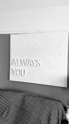 a black and white photo of a bed with the words always you on it