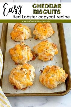 cheddar biscuits on a baking sheet with text overlay that reads easy cheddar biscuits red lobster copycat recipe