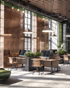 an open office with lots of desks and chairs in front of large windows that have plants growing on them