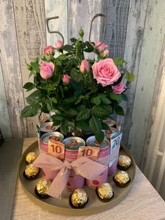 a potted plant sitting on top of a tray filled with chocolates and flowers