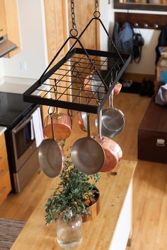 pots and pans hanging from a rack in a kitchen