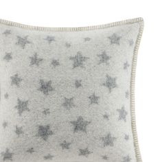 a gray and white pillow with stars on it