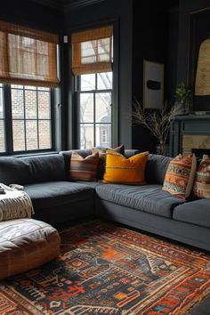 a living room filled with lots of furniture and pillows on top of a large rug