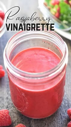 raspberry vinaigrette in a mason jar with strawberries around it