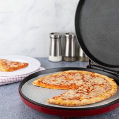 a pizza sitting on top of a pan next to two slices of pizza in it