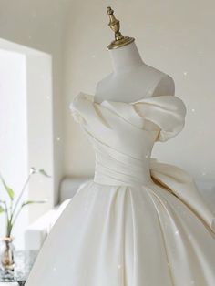 a white dress on a mannequin in a room