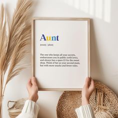 a person holding up a framed print with the words, aunt