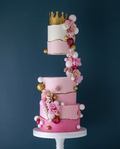 three tiered cake with pink and gold decorations