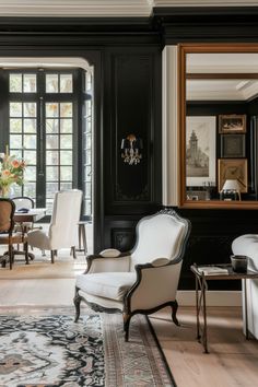 an elegant living room with black walls and white chairs in the center, along with a large area rug on the floor