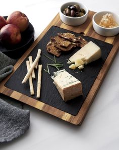 an assortment of cheeses and crackers on a cutting board