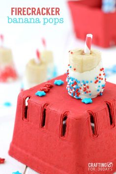 a small cake with candles on it sitting on top of a red table cloth covered in confetti and sprinkles