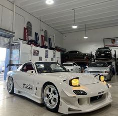 a white sports car parked in a garage