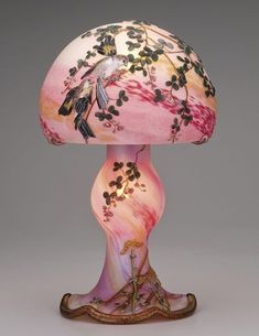 a lamp that is sitting on top of a table next to a mushroom shaped object