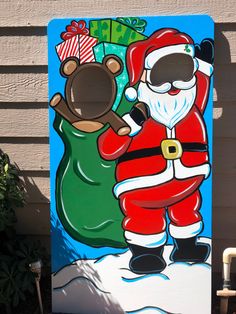 a painting of santa claus holding a teddy bear