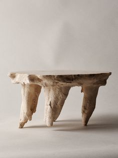 a table made out of driftwood on a white background