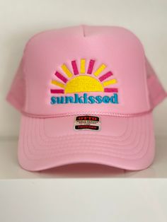 Embroidered "Sunkissed" Pink Trucker Hat Trendy Trucker Hat Visor For Vacation, Trendy Summer Baseball Cap With Flat Brim, Spring Beach Trucker Hat With Flat Brim, Beach Trucker Hat With Embroidered Logo And Curved Brim, Embroidered Snapback Hat For Summer, Trucker Hat With Embroidered Logo For Beach, Pink Summer Trucker Hat, Pink Summer Baseball Cap Dad Hat, Pink Summer Baseball Cap