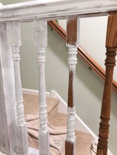 the stairs are painted white and have wooden balconies on top of carpeted steps