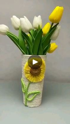 a vase filled with yellow and white flowers