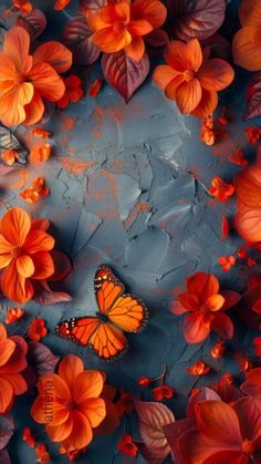 an orange butterfly sitting on top of flowers