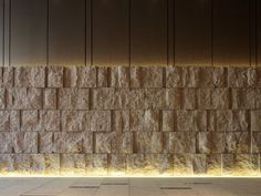 a wall made out of blocks with lights on it's sides and the floor below