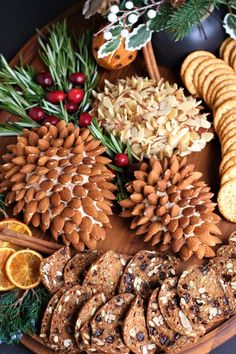 a platter filled with cookies, orange slices and pine cones