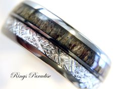 two wedding bands made out of silver and wood