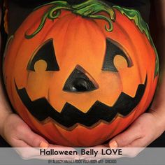 a person holding a carved pumpkin in their hands with the shape of a jack - o'- lantern on it