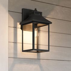 The Laine outdoor lighting collection provides classic styling to outdoor spaces. With a sleek rectangular frame, this 1-light exterior wall lantern looks great on its own or in pairs. Finished in a durable matte black, this fixture is comprised of a composite material called Seaside Armour that is UV resistant and can hold up to bitter cold or brutal heat. Seaside Armour features an impressive five year finish warranty. Shop the rest of the Laine collection for additional exterior lighting options. Quoizel Laine 1-Light 20.5-in H Matte Black Outdoor Wall Light | LWS4455C1 Black Outdoor Wall Lights, Lighting Options, Composite Material, Wall Lantern, Outdoor Ceiling Fans, Outdoor Wall Lights, Exterior Lighting, Outdoor Wall, Decor Lighting