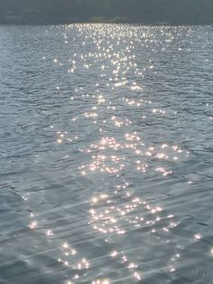 the sun shines on the water as it reflects off the surface