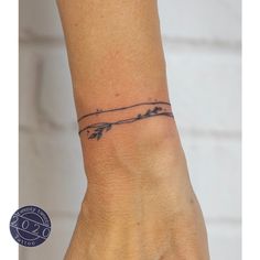 a woman's wrist with a small tattoo on it