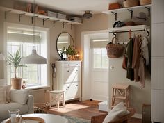 a living room filled with furniture and lots of clutter on top of the shelves