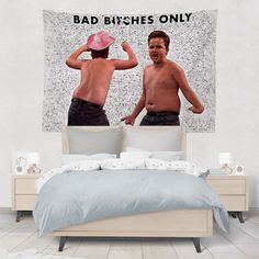 two men are in the same bed and one is wearing a pink hat