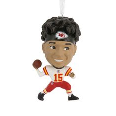 a christmas ornament with a football player on it's head and a ball in his hand