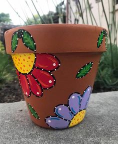 a flower pot with painted flowers on it