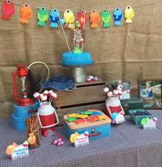 a table topped with lots of cakes and cupcakes