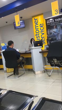 a man sitting at a desk in an airport