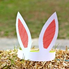 paper bunny ears sitting on top of hay