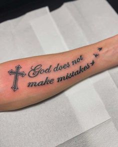 a person with a cross tattoo on their arm