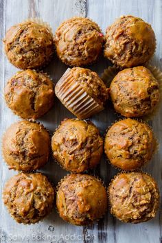 a bunch of muffins sitting on top of a wooden table