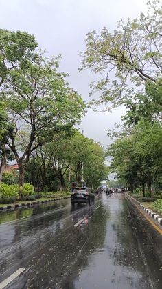 cars driving down the road on a rainy day