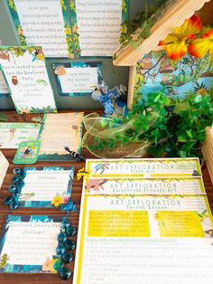 an assortment of stationery items displayed on a table with flowers and books in the background